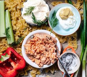 salmon pasta salad, Overhead view of ingredients for salmon pasta salad including flaked canned salmon bowtie pasta mayonnaise sour cream with Dijon celery red bell pepper green onions dill and a small dish of salt and pepper