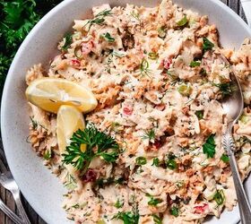 salmon pasta salad, Overhead view of creamy salmon pasta salad with bowtie pasta flaked salmon fresh dill scallions and lemon wedges in a white bowl