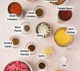 best slow cooker chili with beef and pinto beans, All ingredients for slow cooker beef and pinto bean chili arranged together including ground beef pinto beans tomato sauce diced tomatoes broth onions bell peppers corn and spices