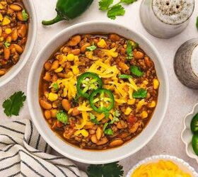 best slow cooker chili with beef and pinto beans, Southwest style chili with ground beef beans corn and spices served in a bowl with fresh toppings