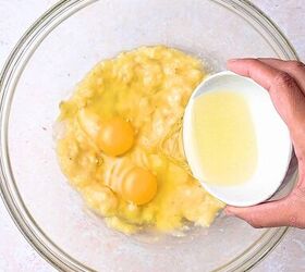 easy banana raspberry muffins with cake mix only 5 ingredients, Mixing 2 eggs and cup vegetable oil into mashed bananas until smooth