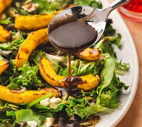 easy roasted pumpkin salad with feta balsamic vinaigrette, Balsamic vinaigrette being drizzled over the roasted pumpkin salad with spring greens feta and pumpkin seeds
