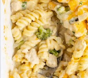 cheesy chicken casserole, Cheesy Chicken Casserole in a casserole dish with a serving spoon in it