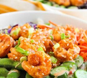 the best bang bang shrimp bowl ready in 30 minutes, Close up of bang bang shrimp bowl with creamy sauce and fresh vegetables