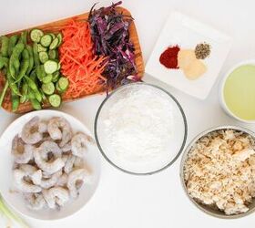 the best bang bang shrimp bowl ready in 30 minutes, Bang bang shrimp bowl ingredients including raw shrimp vegetables rice cornstarch oil and seasonings arranged on a white surface