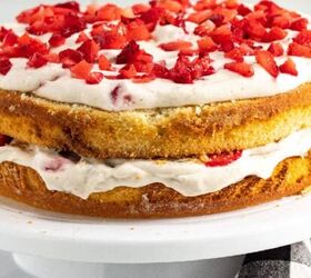 the best bang bang shrimp bowl ready in 30 minutes, Strawberry banana layer cake with vanilla sponge whipped cream frosting and fresh chopped strawberries on top displayed on a white cake stand