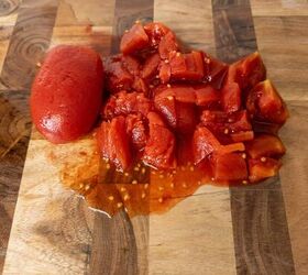 pasta al pomodoro, Canned chopped tomatoes fresh tomato prepared for Italian recipes on wooden cutting board