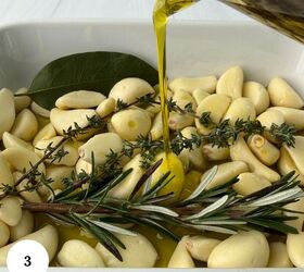 garlic confit with thyme and rosemary, A white dish filled with peeled garlic cloves fresh rosemary thyme and a bay leaf awaits as golden olive oil is poured for a rich garlic confit A white circle with the number 3 is in the bottom left corner