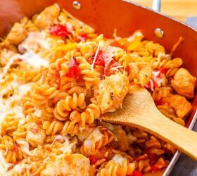 one pot bbq chicken pasta, a spoon lifting out bbq chicken pasta with tomatoes and mozzarella cheese