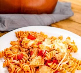 one pot bbq chicken pasta, pasta with chicken tomatoes cheese and bbq sauce on a white plate