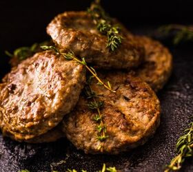 air fryer sausage patties how to cook sausage patties, Air Fryer Sausage Patties on a black plate with herb garnish