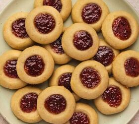 easy valentine s day heart cookies eggless sugar cookies recipe, Raspberry thumbprint cookies arranged in neat rows on parchment paper showing golden edges and bright jam centers