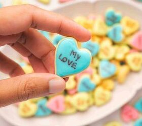 easy mini conversation heart cookies valentine s sugar cookie recipe, Hand holding a mini conversation heart cookie with a love message