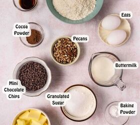 easy red velvet muffins recipe with chocolate chips bakery style, Ingredients for red velvet muffins laid out on a kitchen counter including flour cocoa powder sugar eggs butter buttermilk red food coloring chocolate chips and chopped pecans