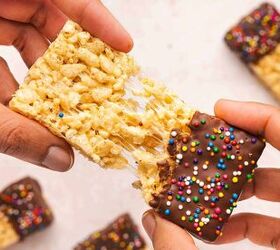 how to make chocolate dipped rice krispie treats, Close up of a chocolate dipped Rice Krispie treat being pulled apart by hand revealing the soft and gooey marshmallow center