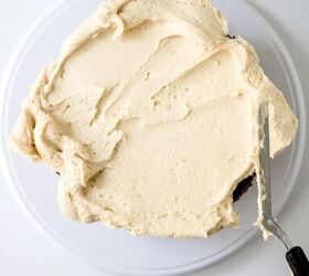 chocolate caramel cake recipe rich moist easy, Buttercream frosting spread over the top of the chocolate cake with an offset spatula