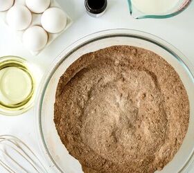 chocolate caramel cake recipe rich moist easy, Dry chocolate cake ingredients whisked together in a large glass mixing bowl on a white surface