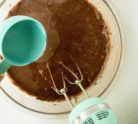 chocolate caramel cake recipe rich moist easy, Water being poured into chocolate cake batter while mixing with an electric hand mixer