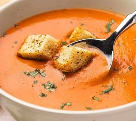 easy creamy roasted red pepper gouda soup recipe, Spoon scooping creamy roasted red pepper Gouda soup from bowl