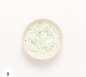 mediterranean chicken couscous bowl, A Mediterranean bowl filled with a creamy white dip mixed with green herbs sits on a white surface The number 3 is displayed in a white circle in the bottom left corner