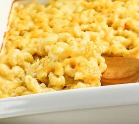 3 cheese macaroni and cheese recipe for pure comfort, Close up of creamy baked three cheese macaroni and cheese being scooped with a wooden spoon