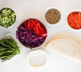 rainbow veggie pinwheels recipe easy and colorful, Ingredients for veggie pinwheels including flour tortillas creamy spread broccoli spinach shredded carrots red cabbage red bell peppers and sunflower seeds arranged on a white background