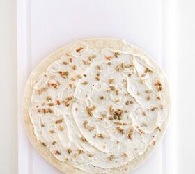 rainbow veggie pinwheels recipe easy and colorful, Tortilla topped with creamy spread and sprinkled seeds before adding vegetables