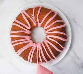 easter bundt cake recipe for spring celebrations, Pink icing being drizzled over a baked Easter bundt cake on a white plate