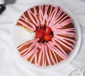 easter bundt cake recipe for spring celebrations, Sliced Easter bundt cake with pink icing and fresh strawberries on a serving plate