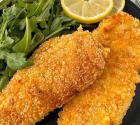 creamy chicken orzo bake one pan dinner, A black plate with two crispy Gluten Free Chicken Milanese fillets a handful of fresh arugula two slices of lemon and cherry tomatoes in the background A fork and napkin are beside the plate