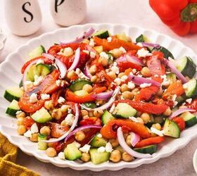 easy roasted red bell pepper and chickpea salad recipe, Mediterranean style roasted red pepper salad with chickpeas cucumber and feta on a white platter