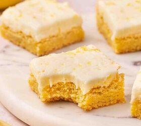 easy soft lemon sugar cookie bars best dessert for spring, Close up of a soft lemon sugar cookie bar with a bite taken out showing the tender texture and creamy lemon buttercream inside