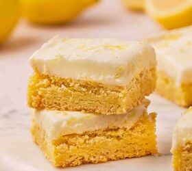 easy soft lemon sugar cookie bars best dessert for spring, Stack of two soft lemon sugar cookie bars on a marble slab with creamy lemon buttercream and fresh lemon zest