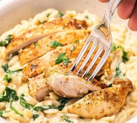 easy baked chicken orzo a one pan dinner recipe, Close up shot of creamy baked chicken orzo in a bowl garnished with lemon zest and fresh parsley