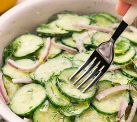 creamy cucumber dill salad easy salad with yogurt dressing, Fork lifting creamy cucumber dill salad with cucumbers red onions and yogurt dressing