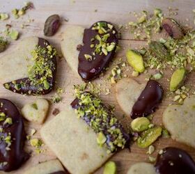 pistachio cookies dipped in dark chocolate, pistachio cookies dipped into chocolate and sprinkled with chopped green pistachio s