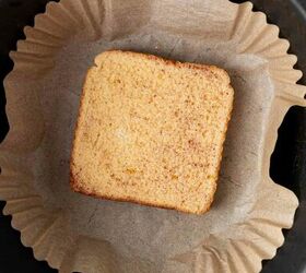 air fryer french toast easy ready in minutes, A slice of soaked bread sits on a piece of brown parchment paper inside an air fryer basket