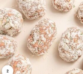 greek beef meatballs in tomato sauce soutzoukakia, Several uncooked Greek beef meatballs coated in flour are arranged on a light colored surface There are visible green herb pieces in the soutzoukakia mixture A small white circle with the number 2 is in the lower left corner