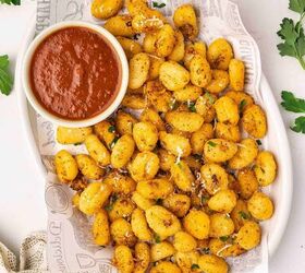 crispy air fryer gnocchi recipe easy snack ready in minutes, Golden crispy air fryer gnocchi served on a platter with a bowl of marinara sauce for dipping garnished with Parmesan and parsley