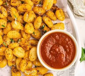 crispy air fryer gnocchi recipe easy snack ready in minutes, Crispy gnocchi on a platter sprinkled with Parmesan and parsley with a small bowl of marinara sauce for dipping
