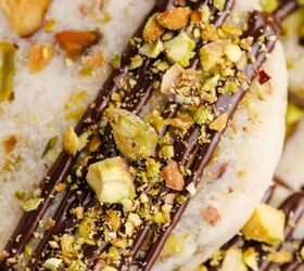 pistachio shortbread cookies, Pistachio Shortbread Cookies up close with chocolate drizzle and crushed nuts on top