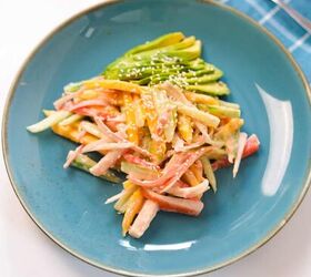 quick and easy spicy crab salad in just 15 minutes, Spicy crab salad garnished with sesame seeds and avocado slices on a blue plate