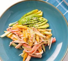 quick and easy spicy crab salad in just 15 minutes, Creamy spicy crab salad plated with fresh avocado and sesame seeds on a blue dish