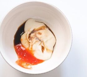 quick and easy spicy crab salad in just 15 minutes, Mayonnaise sriracha and soy sauce added together in a small white bowl before mixing
