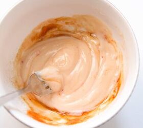 quick and easy spicy crab salad in just 15 minutes, Mayonnaise sriracha and soy sauce added together in a small white bowl before mixing