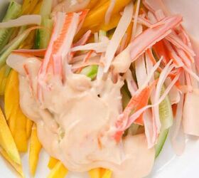 quick and easy spicy crab salad in just 15 minutes, Julienned mango cucumber and crab topped with spicy mayo dressing in a mixing bowl