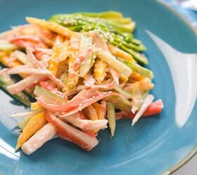 quick and easy spicy crab salad in just 15 minutes, Close up of creamy spicy crab salad with mango and cucumber on a blue ceramic plate