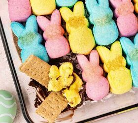 easy 4 ingredient peeps s mores dip for easter, Colorful Peeps marshmallows melting over chocolate as a graham cracker scoops a bite of Easter s mores dip