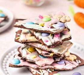 pastel easter chocolate bark the best candy treat for easter, Stacked pieces of Pastel Easter Chocolate Bark on a platter showing layers of chocolate colorful candy melts and festive Easter toppings