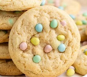 easter brownies, Cadbury Mini Egg Cookies stacked on a baking sheet with mini eggs all around